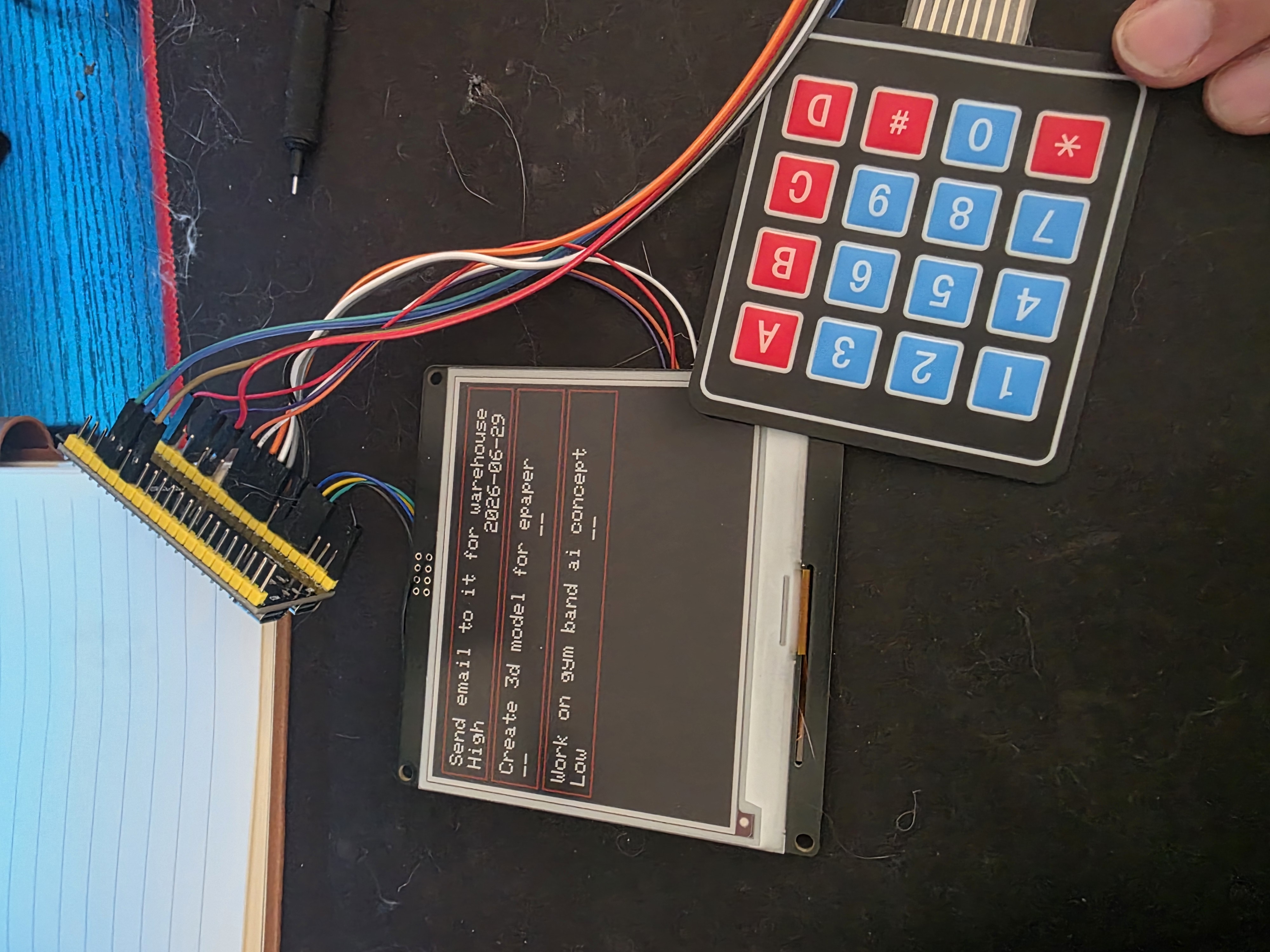 E-paper display showing a task list, wired to a 4x4 keypad