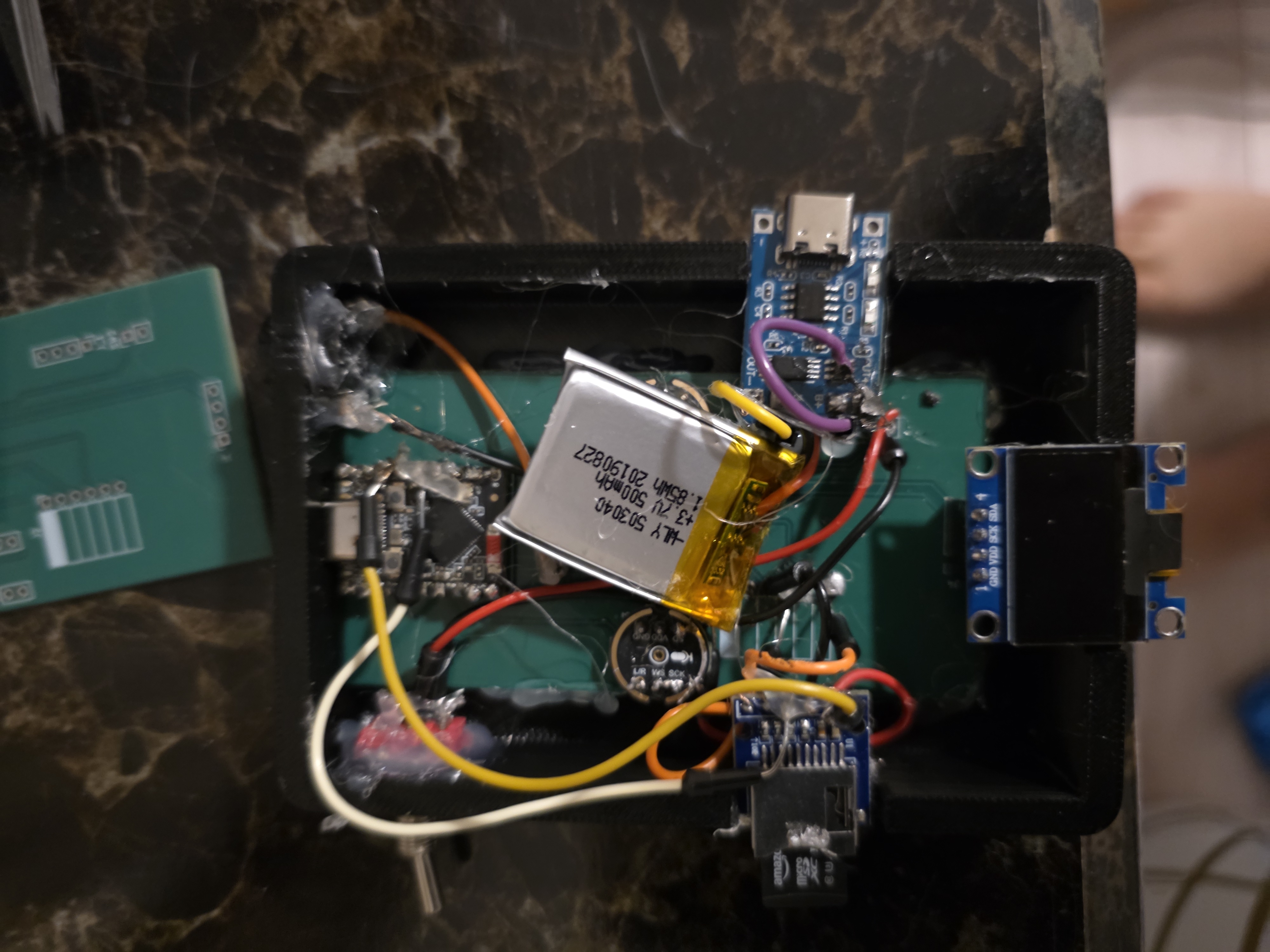 Open enclosure showing the custom PCB, battery, and wiring